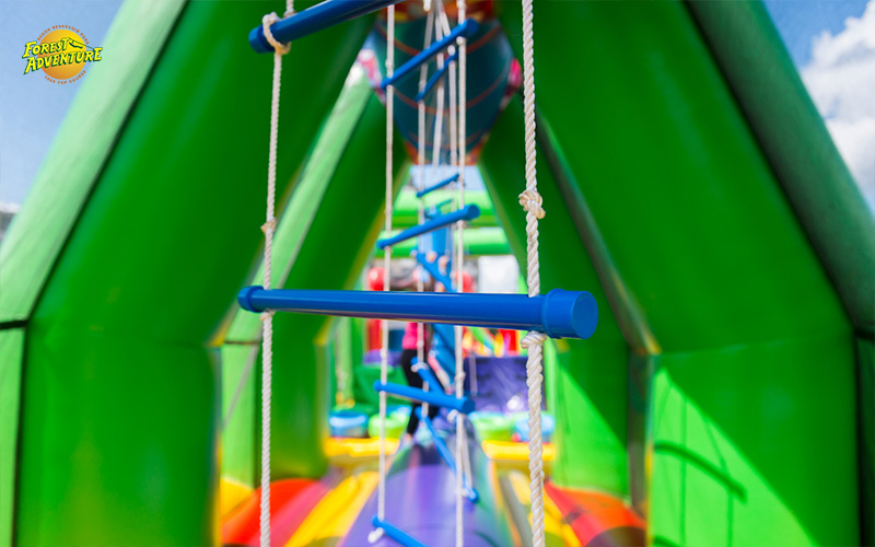 Colorful inflatable obstacle course with rope ladder